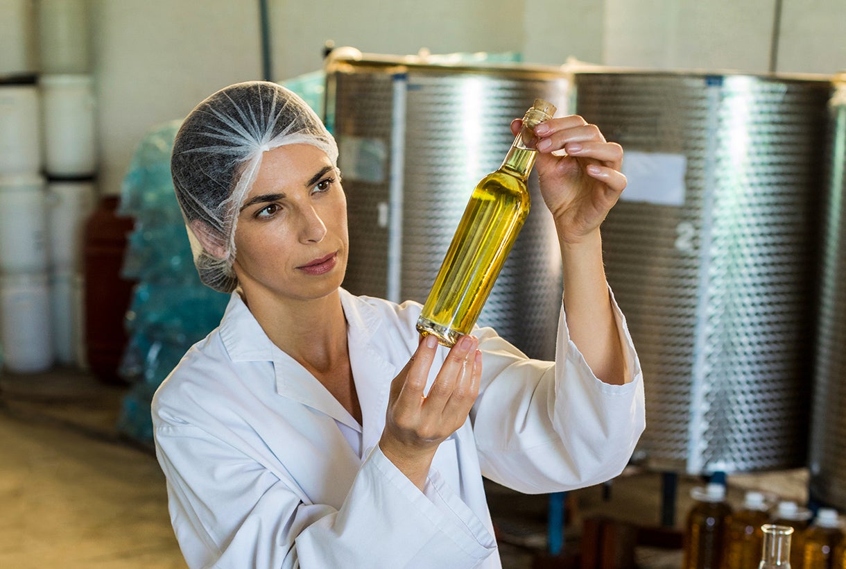 technician examining olive oil